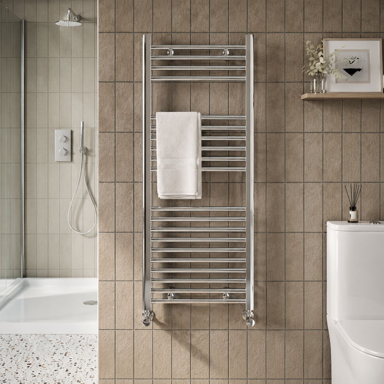 Chrome ladder heated towel rail in tiled bathroom — Bathroom Republic UK
