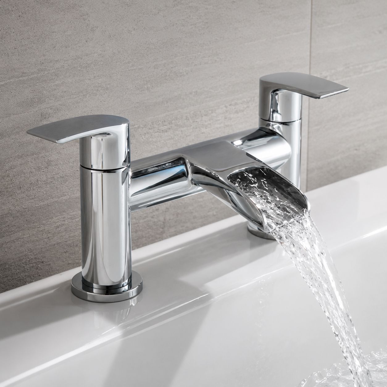 Chrome waterfall bath mixer tap running over a white bath — Bathroom Republic UK