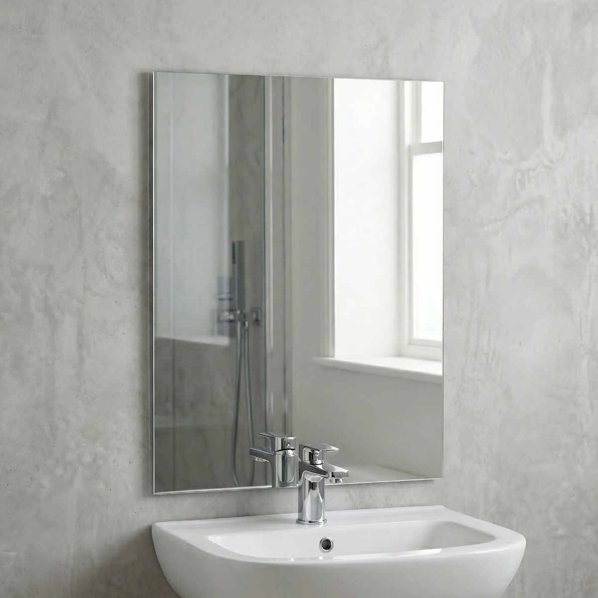 Round frameless bathroom mirror on a grey tiled wall — Bathroom Republic UK