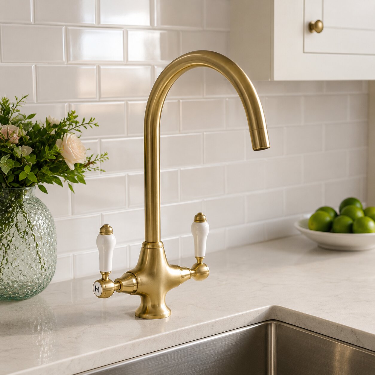 Brushed brass bridge kitchen tap on a white sink — Bathroom Republic UK