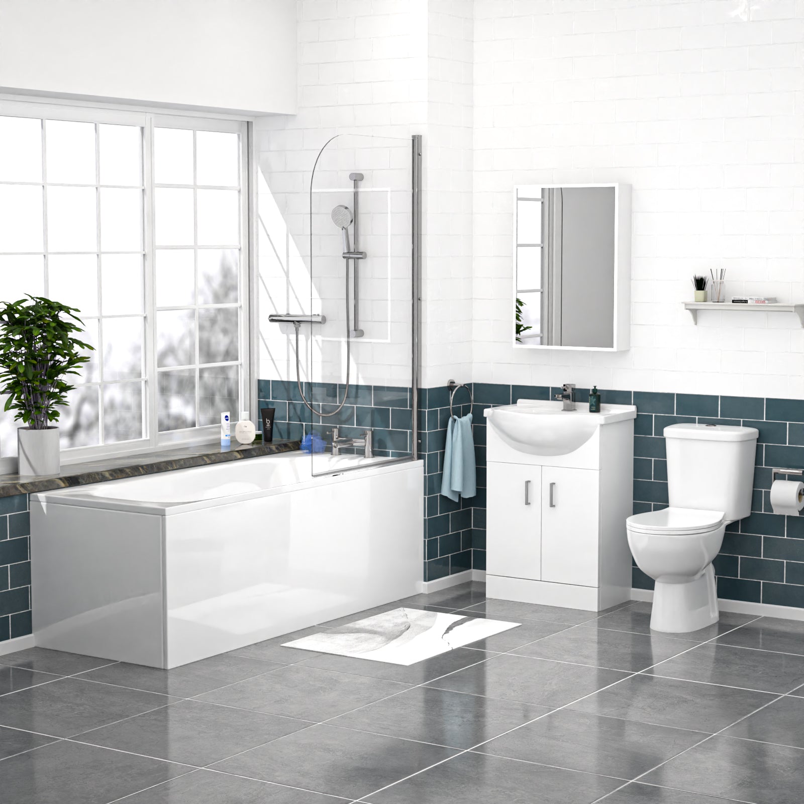 Modern bathroom with white bathtub, toilet, and vanity unit against a blue tiled wall.