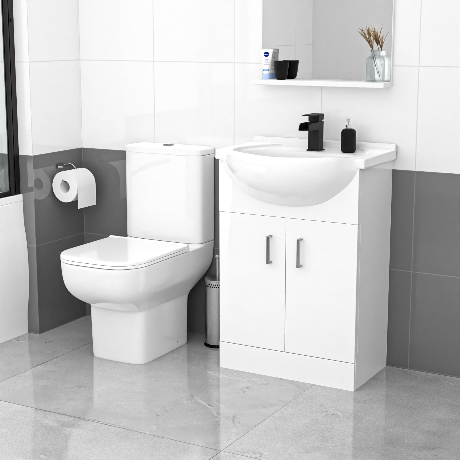 Modern bathroom with white toilet and vanity unit against a gray tiled wall.