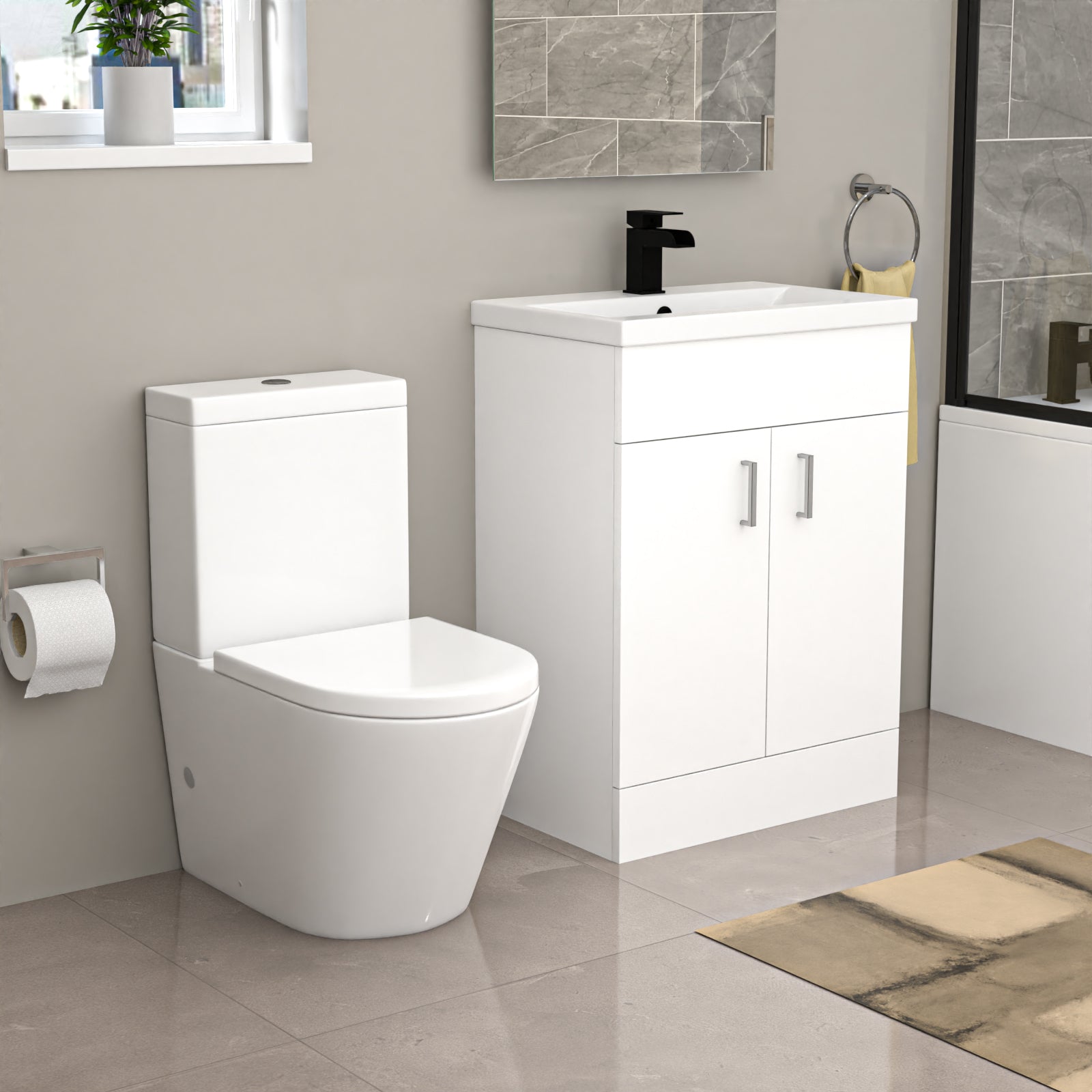 Bathroom setup with a white toilet and vanity unit against a gray wall.