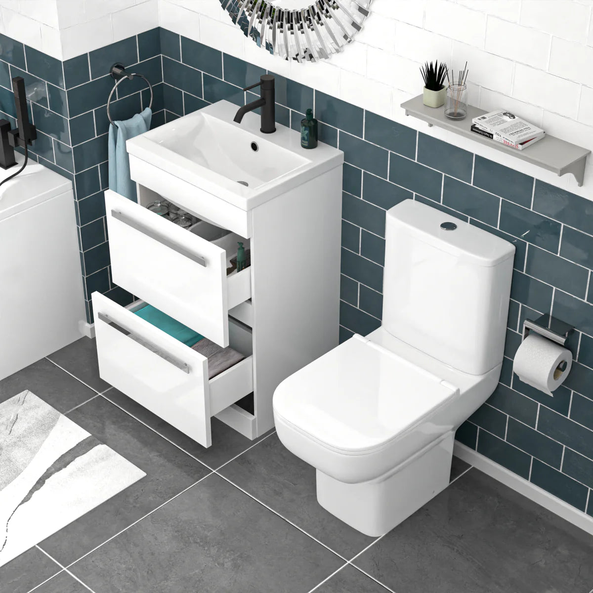 Bathroom setup with white vanity unit, toilet, and sink against a blue tiled wall.