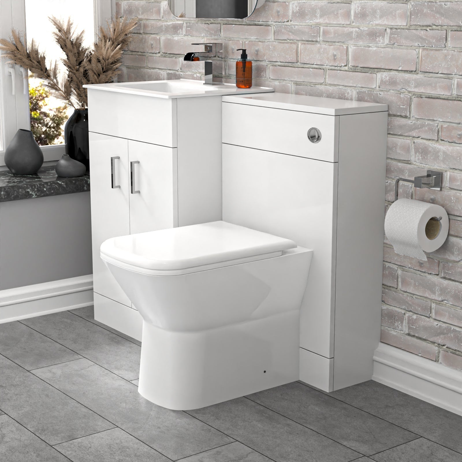 Bathroom setup with a white toilet and vanity unit against a stone wall.