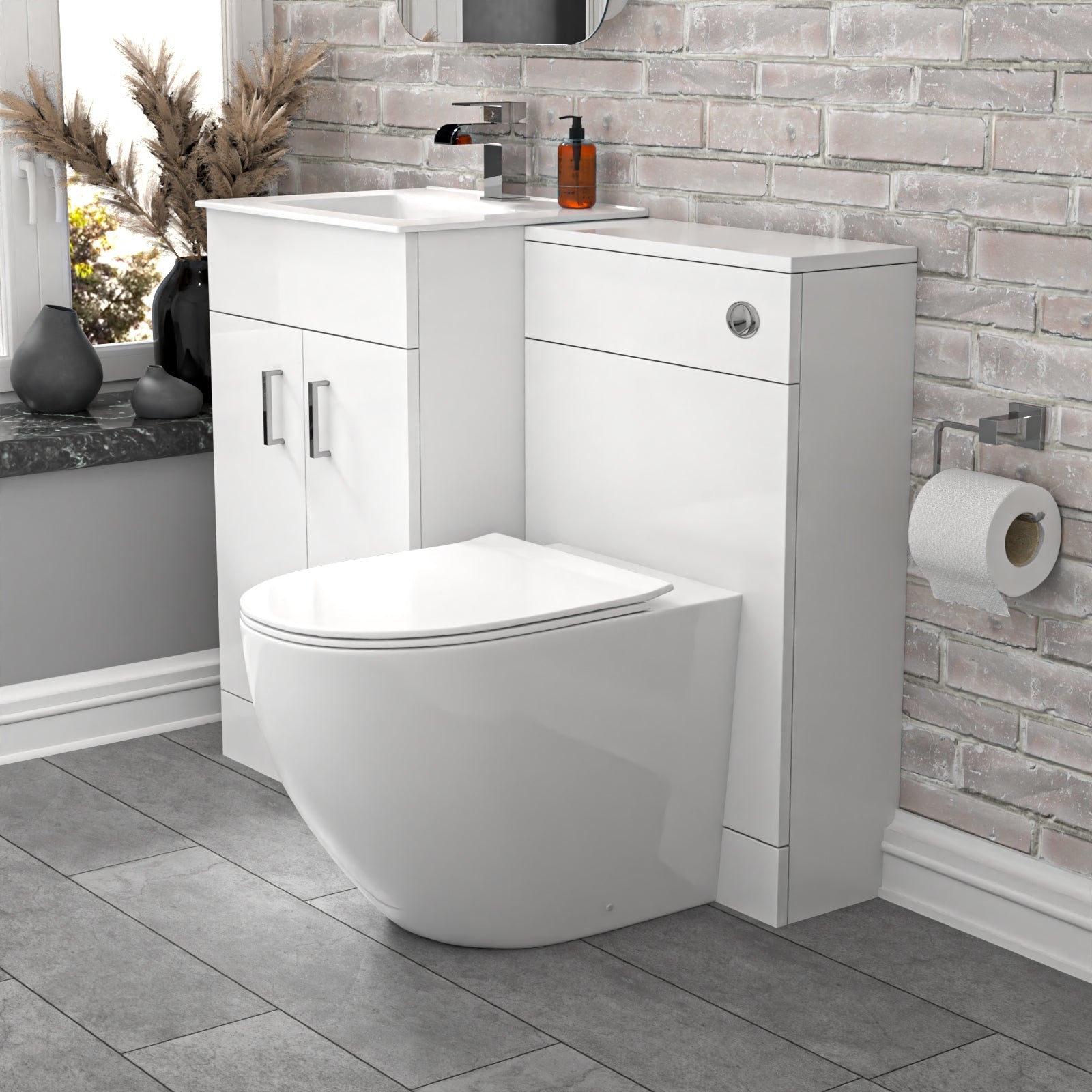 Bathroom setup with a toilet and vanity unit against a stone wall.