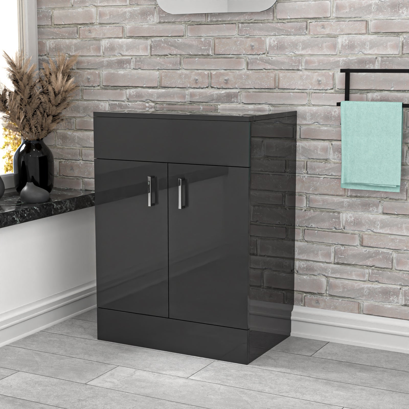 Black cabinet in a bathroom setting with a stone wall and towel rack.