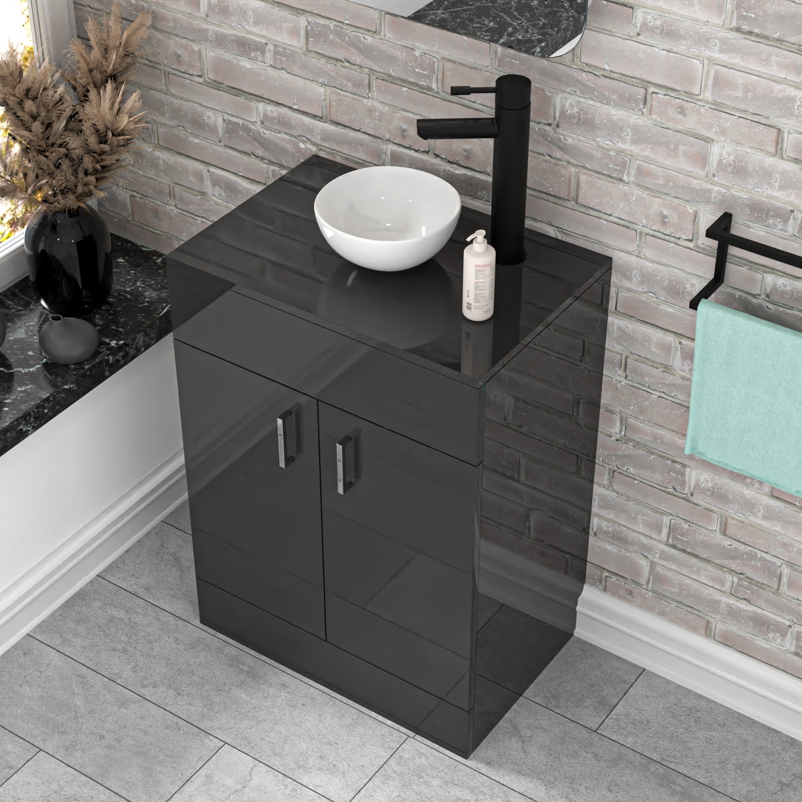 Bathroom setup with black vanity unit, white basin, and towel rack against a brick wall.