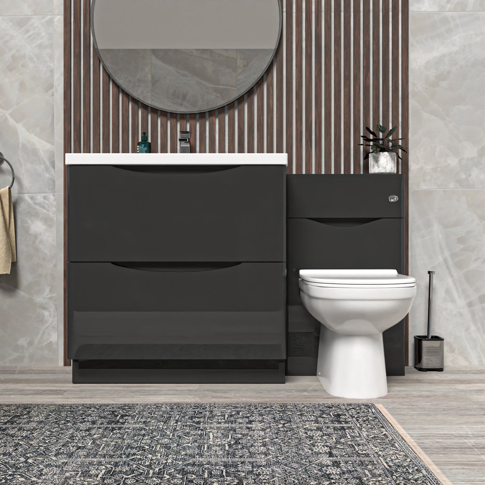 Bathroom setup with dark Gray vanity unit, white toilet, and round mirror.