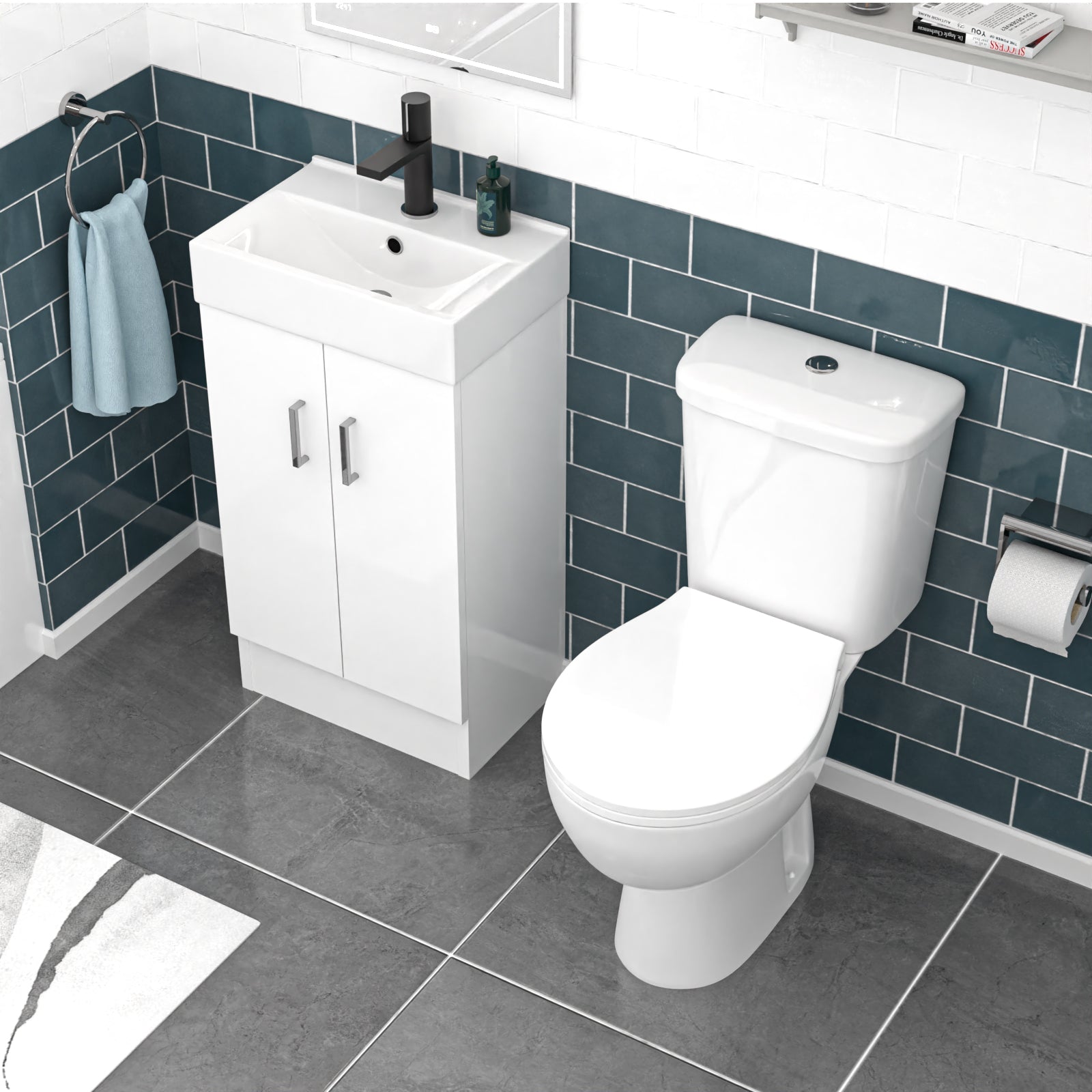 Bathroom setup with white toilet and sink against a blue tiled wall.