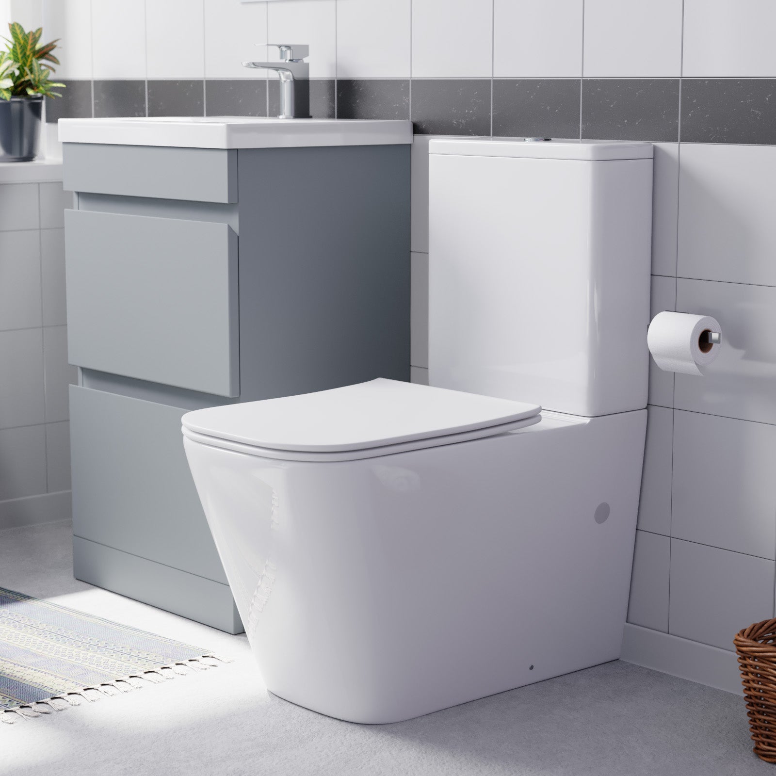 Modern bathroom setup with a toilet, sink, and cabinet.