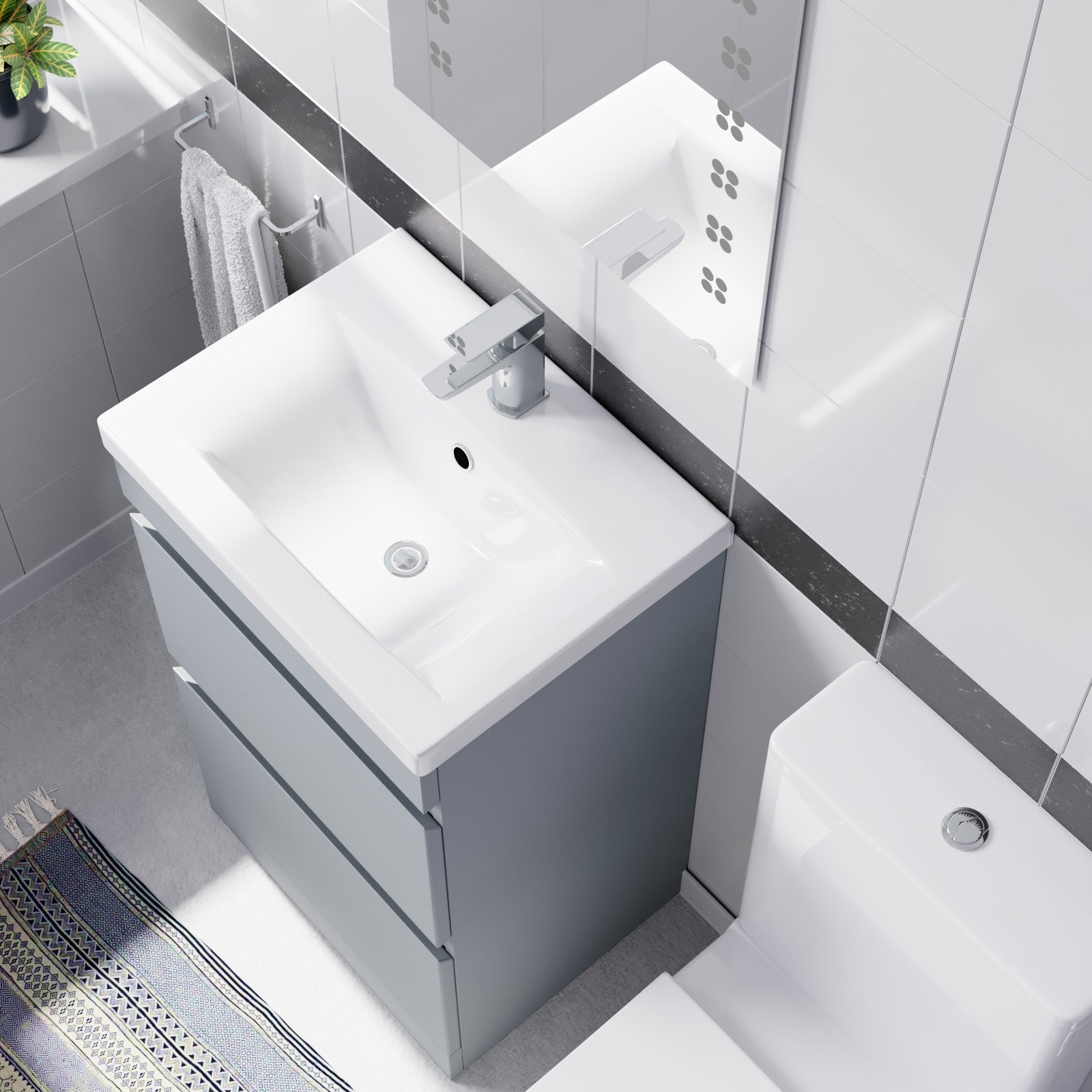 Bathroom vanity with white sink and gray cabinet in a modern bathroom setting.