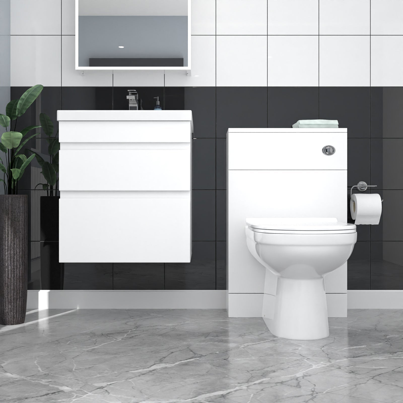 Bathroom setup with a white vanity unit and toilet against a black and white tiled wall.