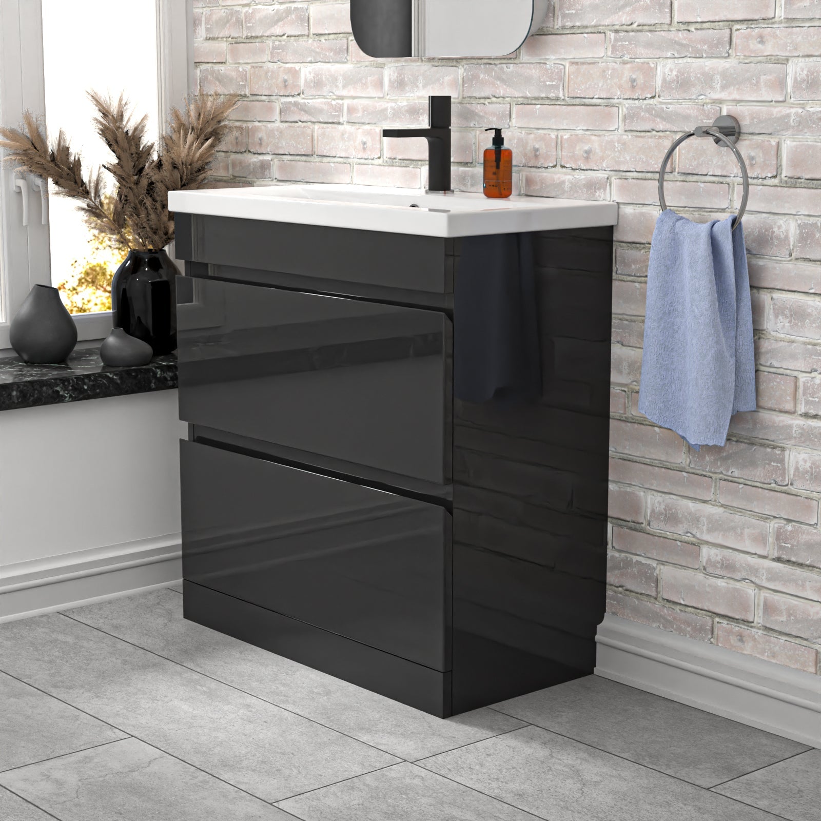 Bathroom vanity with sink, drawers, and towel hanging on a wall.