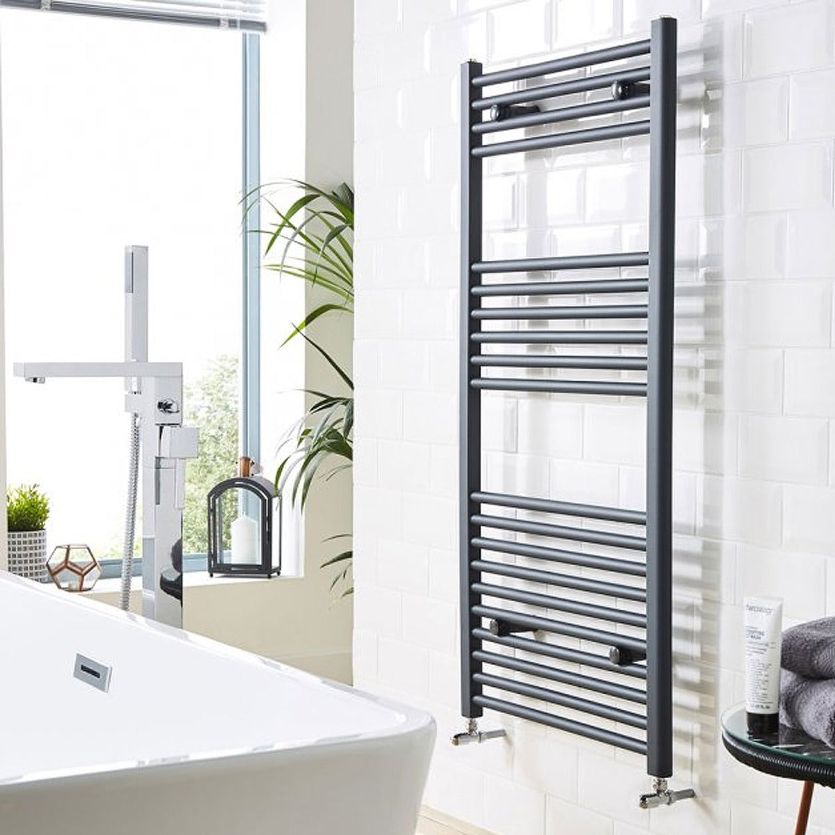 Towel radiator in a bathroom with a bathtub and window