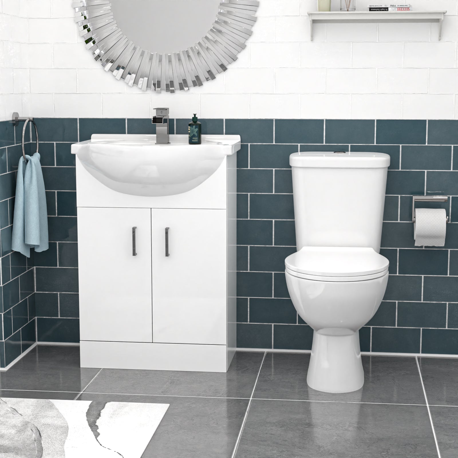 Bathroom with white toilet and sink against a blue tiled wall.