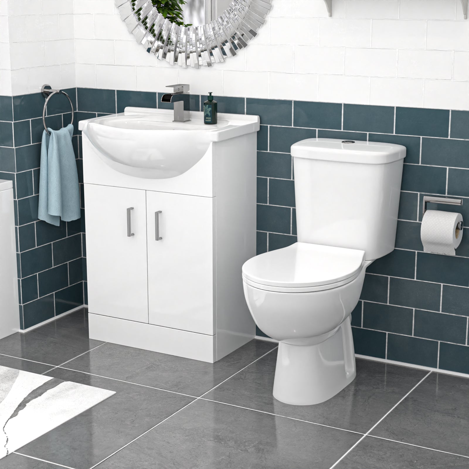 Bathroom setup with a white toilet and vanity unit against a blue tiled wall.