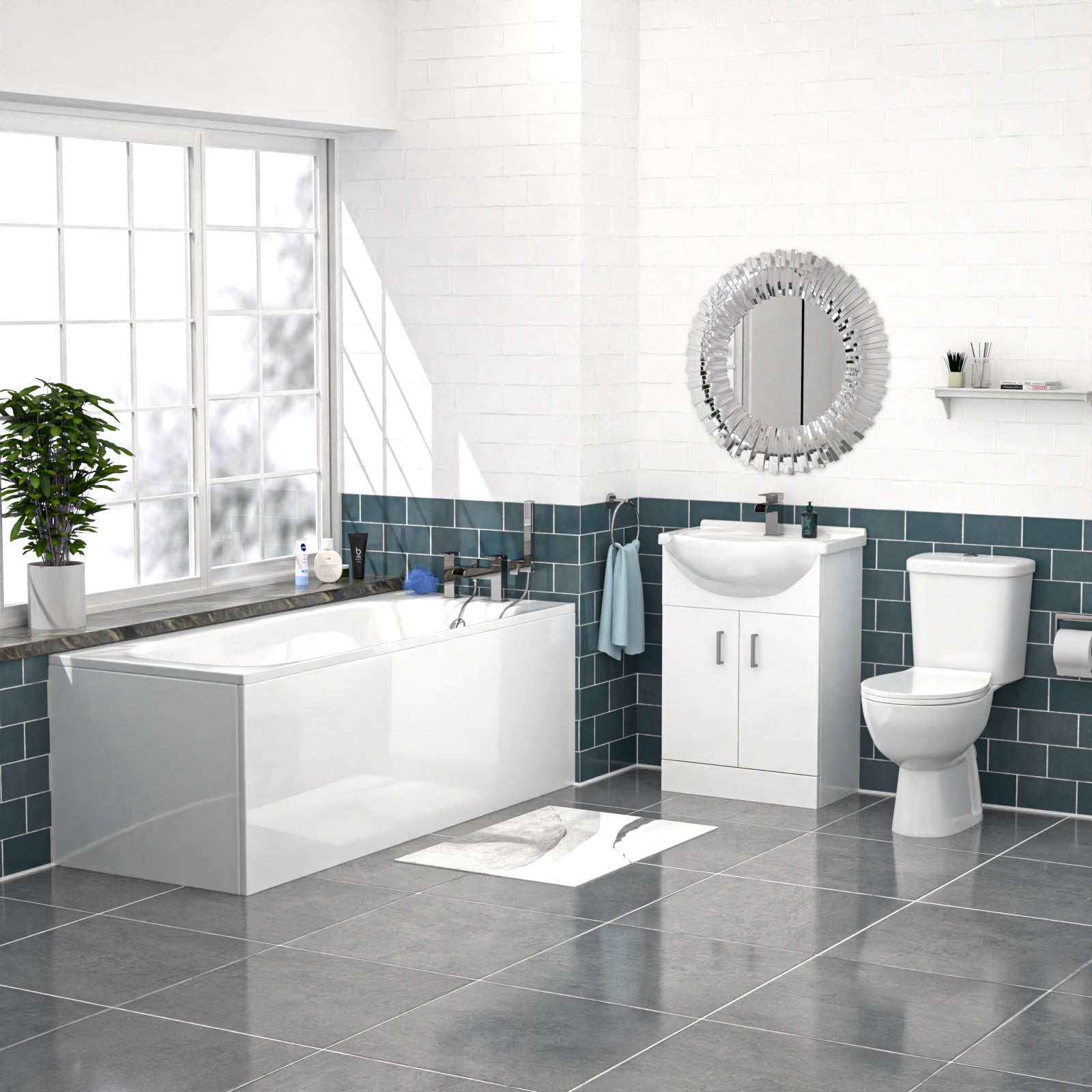 Modern bathroom with white bathtub, sink, and toilet against a blue tiled wall.