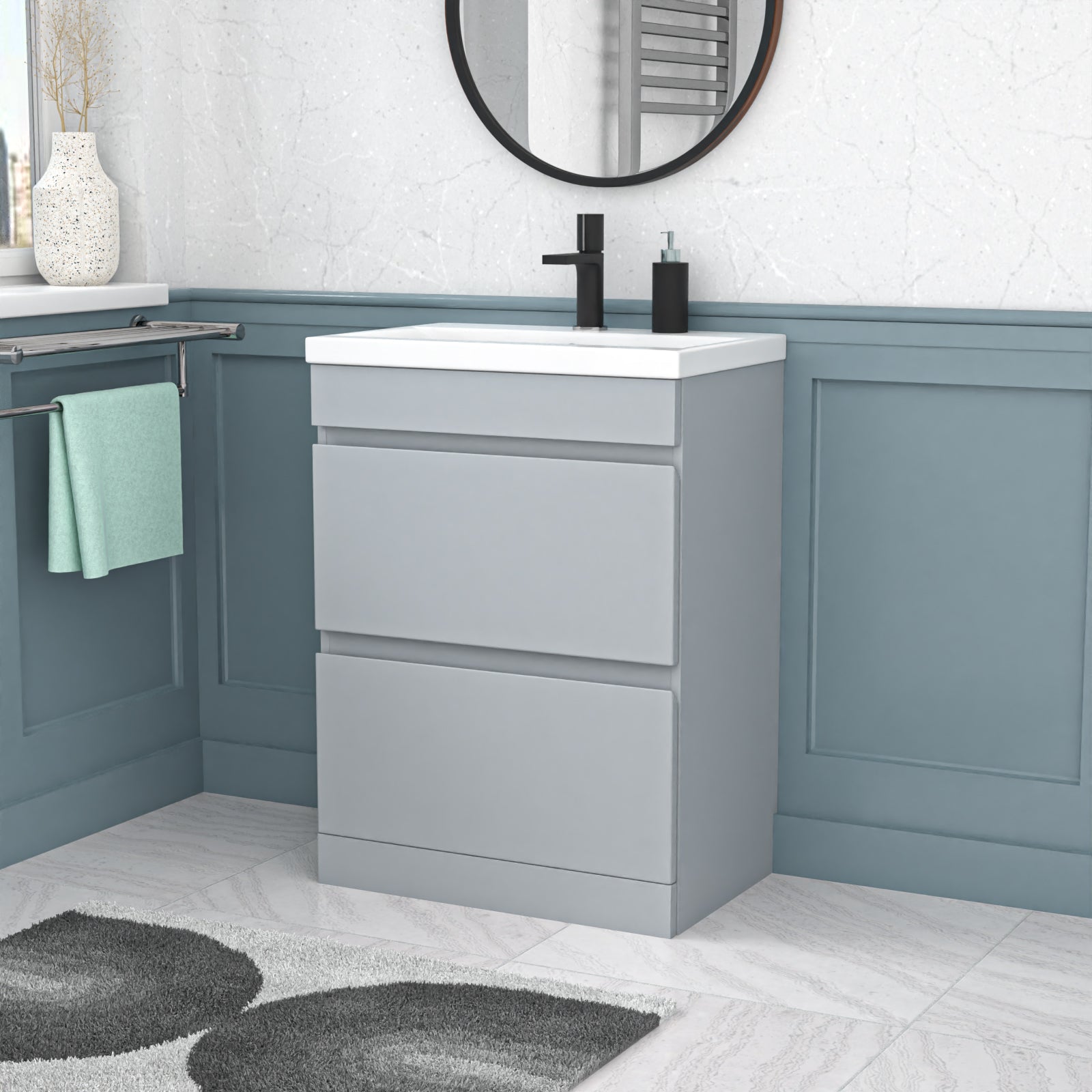Bathroom vanity with white countertop and gray cabinet against a light blue wall.