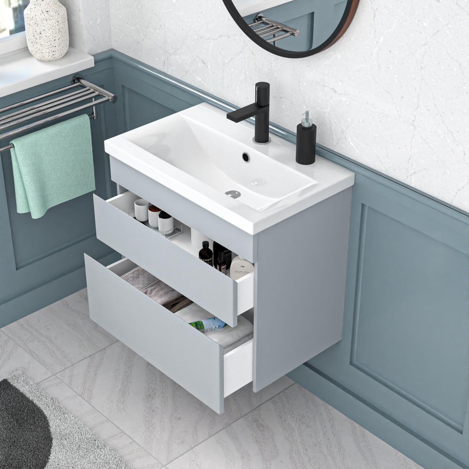 Bathroom vanity with white sink and open drawer, featuring a mirror and towel rack.