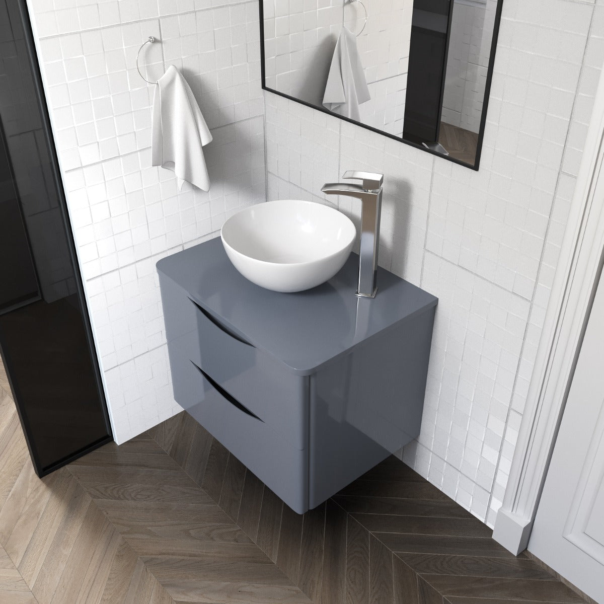 Bathroom vanity with gray cabinet and white sink against a tiled wall.
