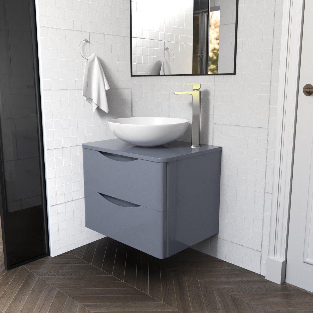Bathroom with gray vanity, white sink, and mirror on a tiled wall.
