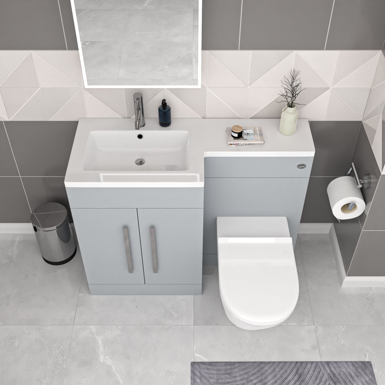 Bathroom setup with a vanity unit, sink, and toilet in a tiled bathroom.