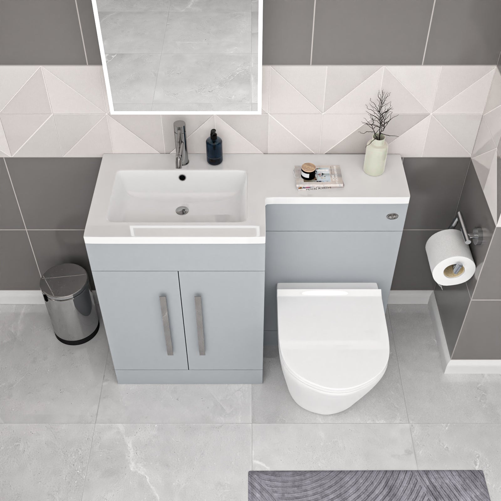 Bathroom setup with a sink, toilet, and vanity unit against a tiled wall.