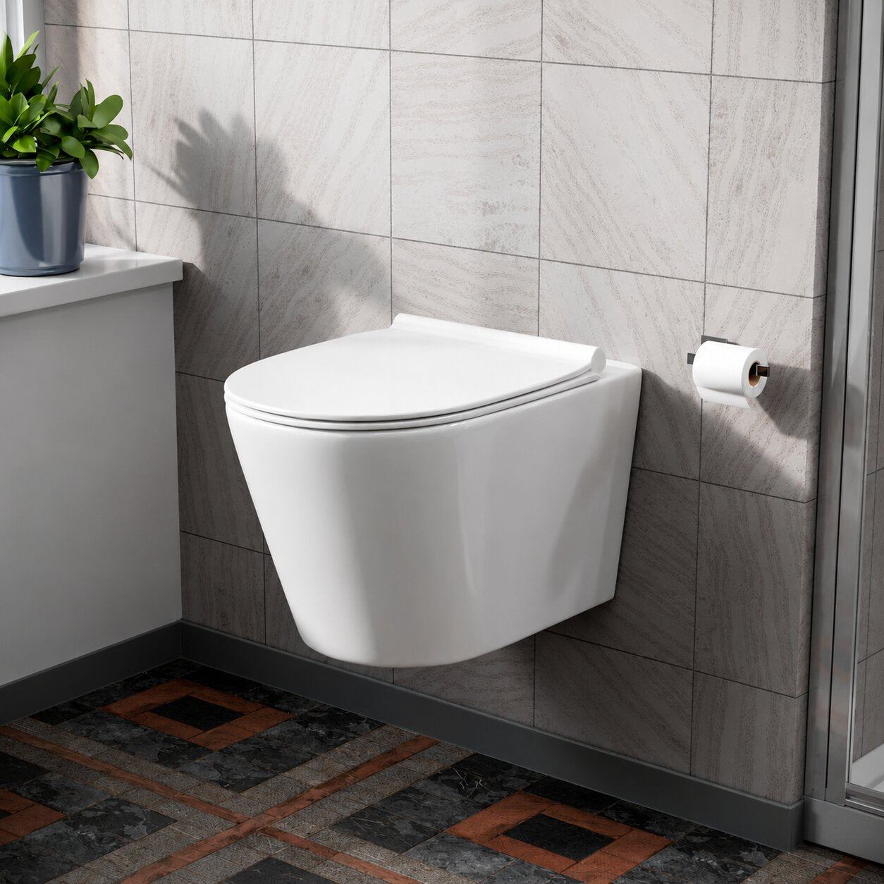 White wall hung toilet pan fixed to concealed in-wall carrier frame against grey panelled bathroom wall — Bathroom Republic UK