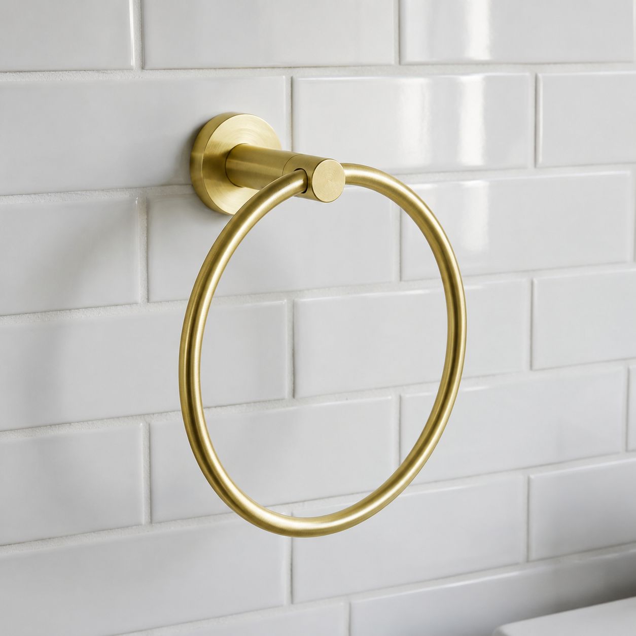 Brushed brass towel ring mounted on white tiled bathroom wall — Bathroom Republic UK