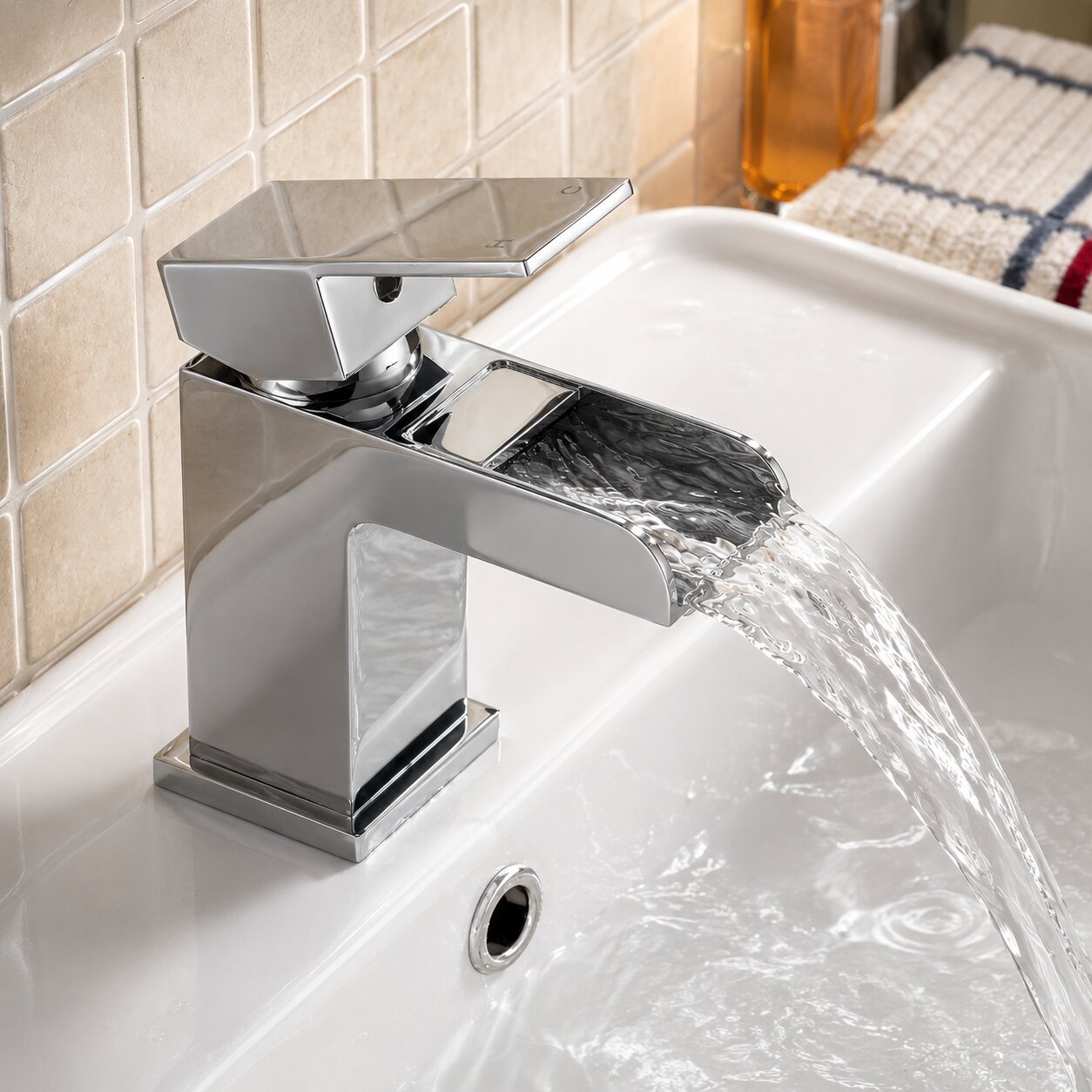 Chrome waterfall basin tap with wide sheet-flow spout on a white basin — Bathroom Republic UK