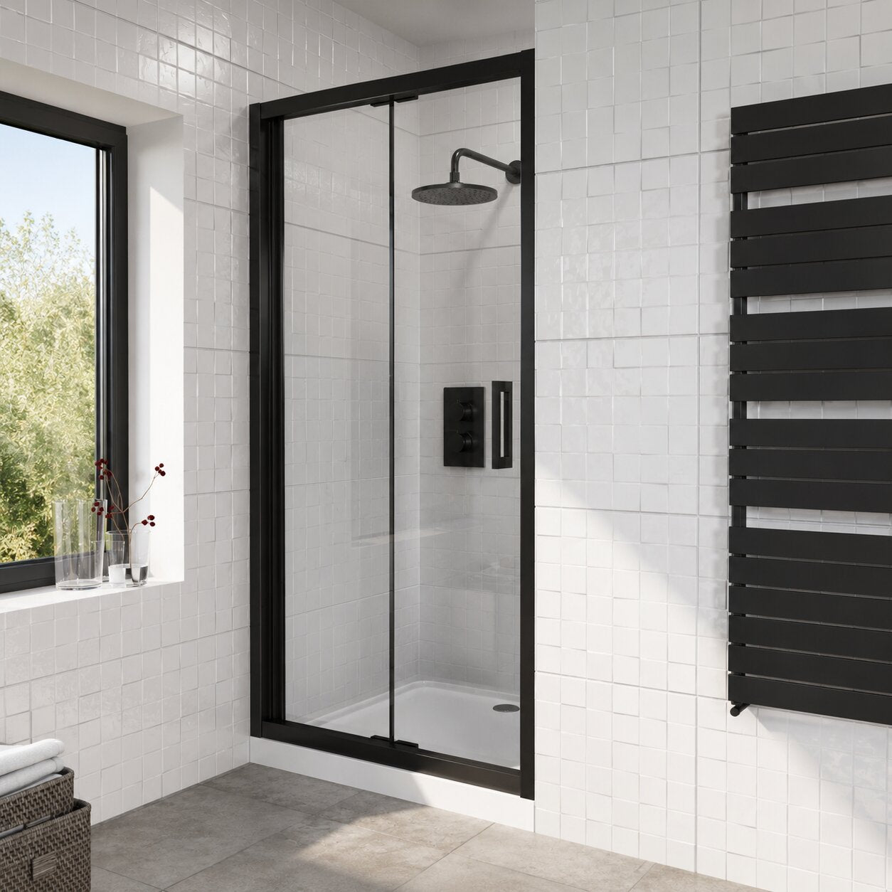 Matte black bi-fold shower door panel showing Z-fold mechanism in alcove installation — Bathroom Republic UK