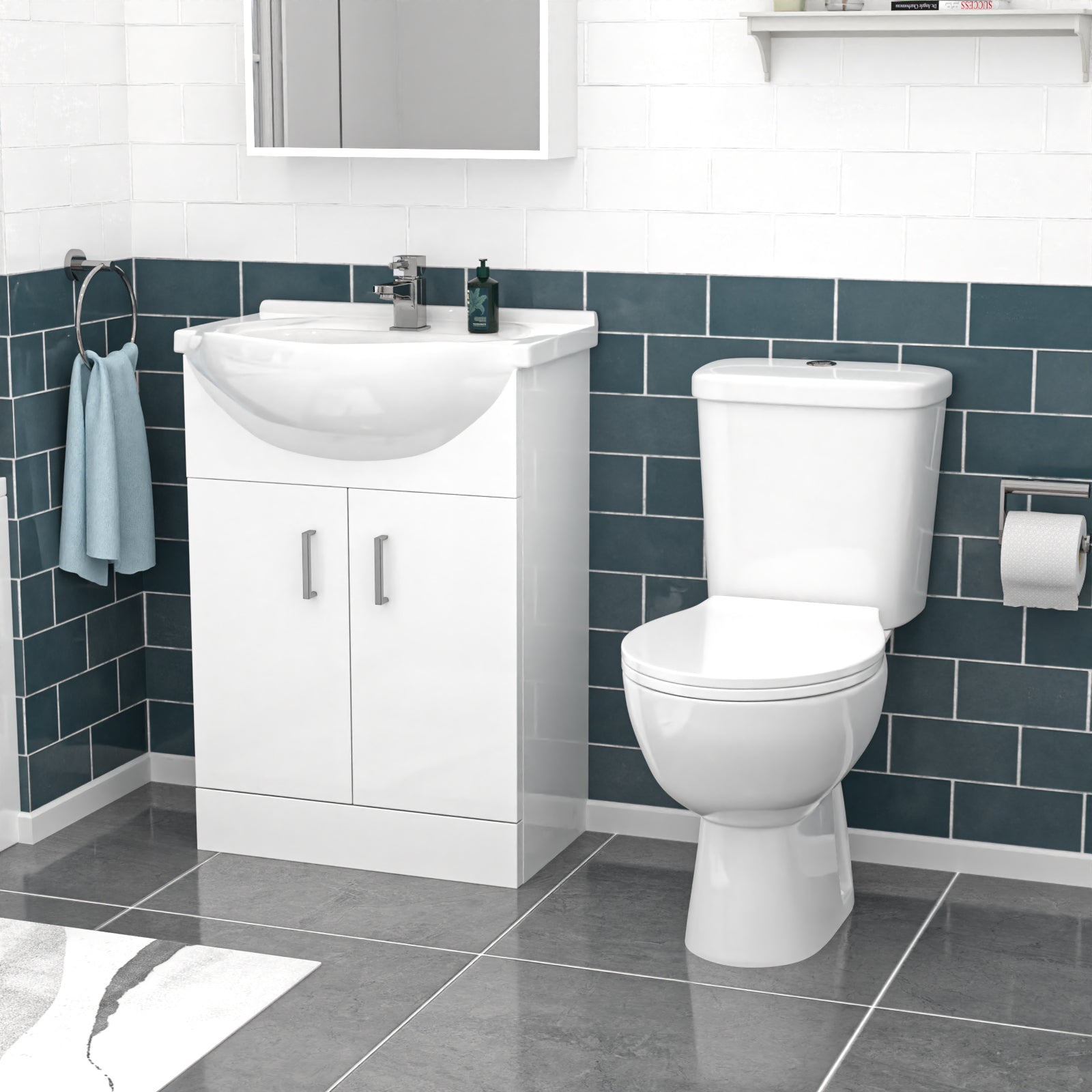 Bathroom setup with white toilet and vanity unit against a blue tiled wall.