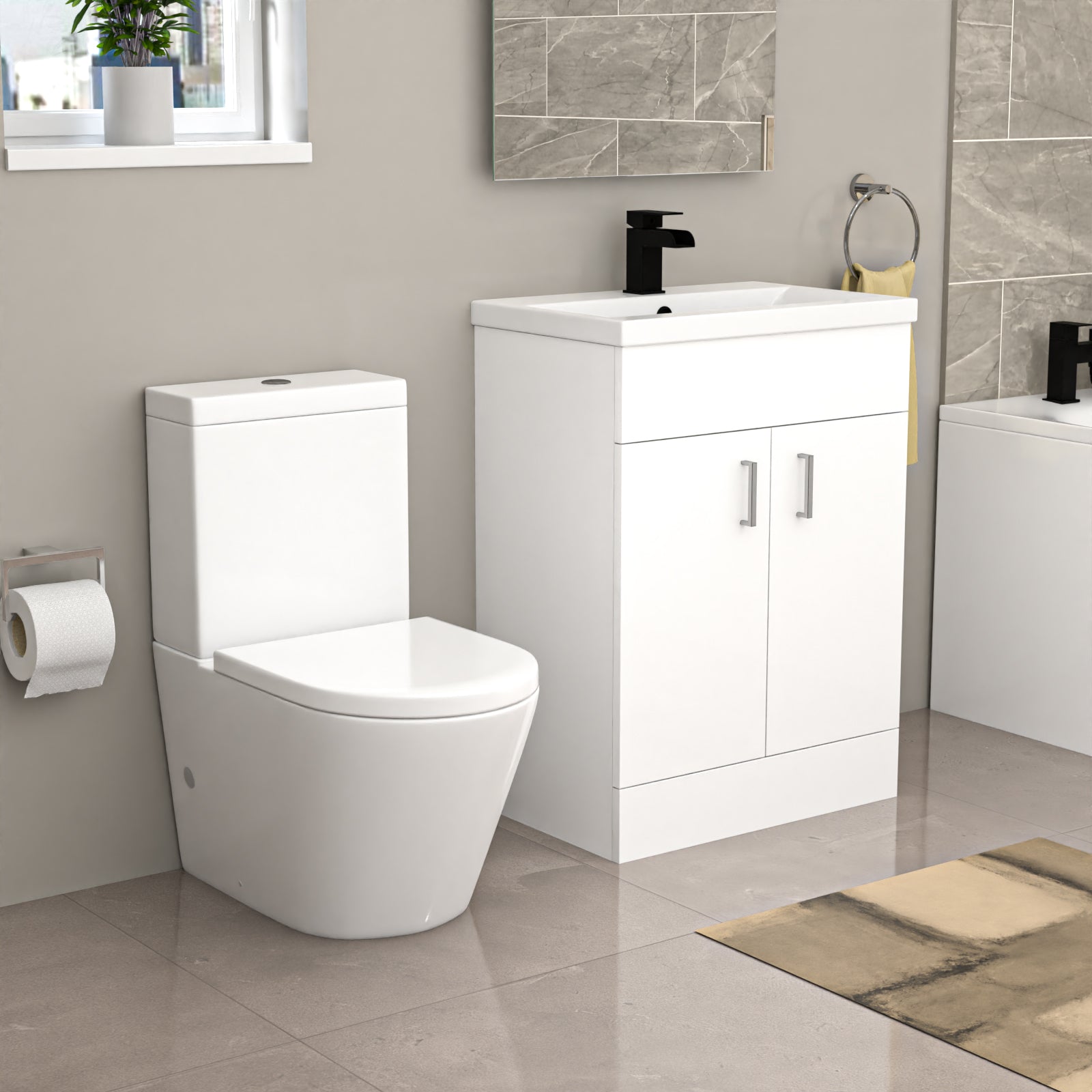 Bathroom fixtures with a toilet, vanity unit, bathtub in a tiled bathroom.