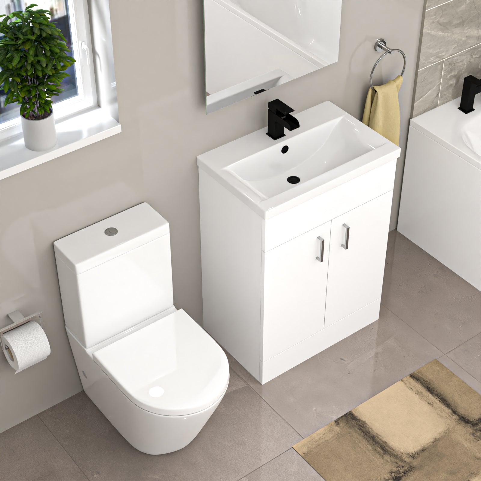 Bathroom setup with white toilet, sink, vanity unit, and bathtub in a tiled bathroom.