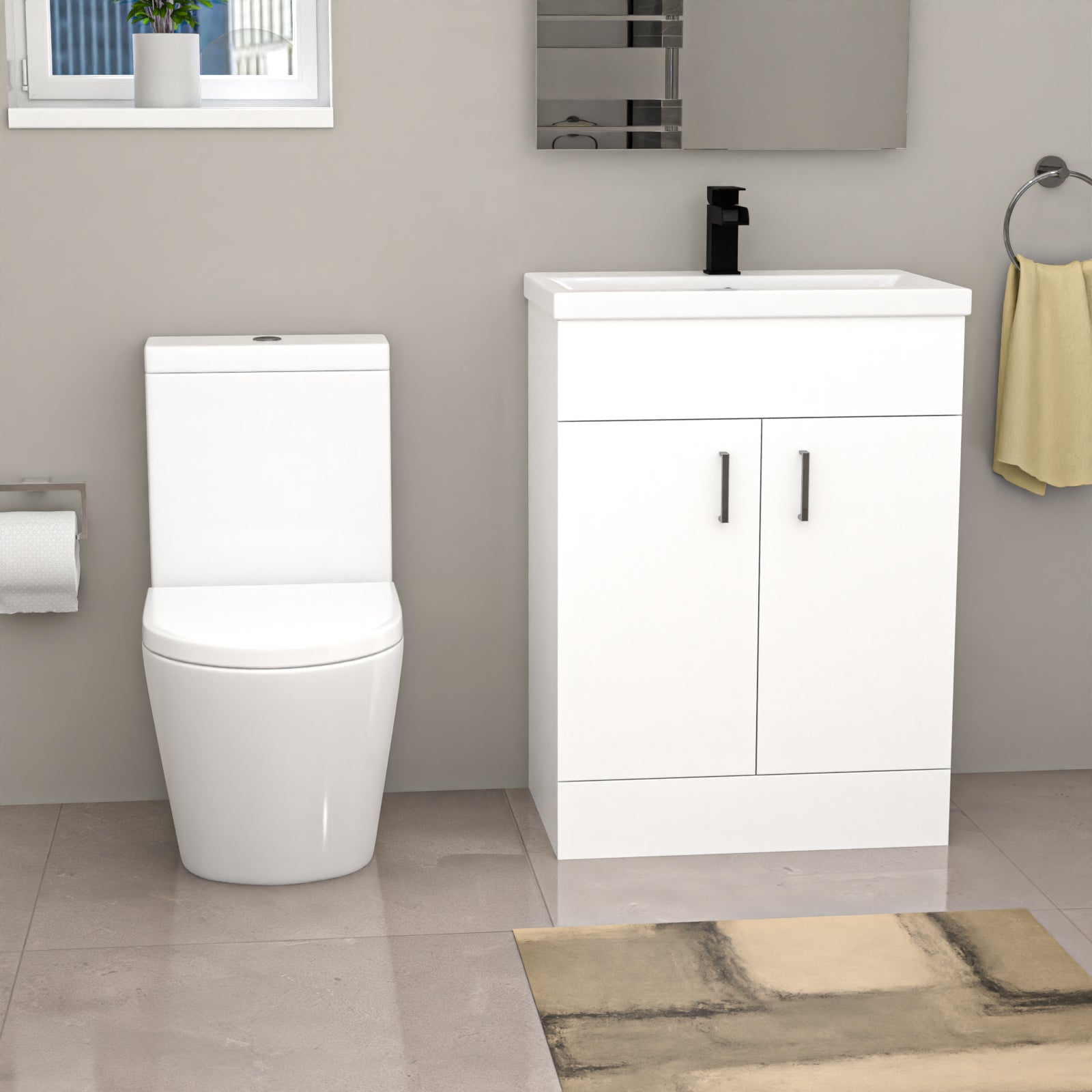 Bathroom setup with a white toilet and vanity unit against a gray wall.