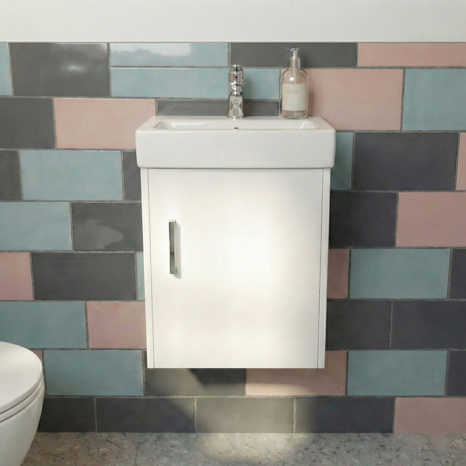 Bathroom vanity with sink against a colorful tiled wall