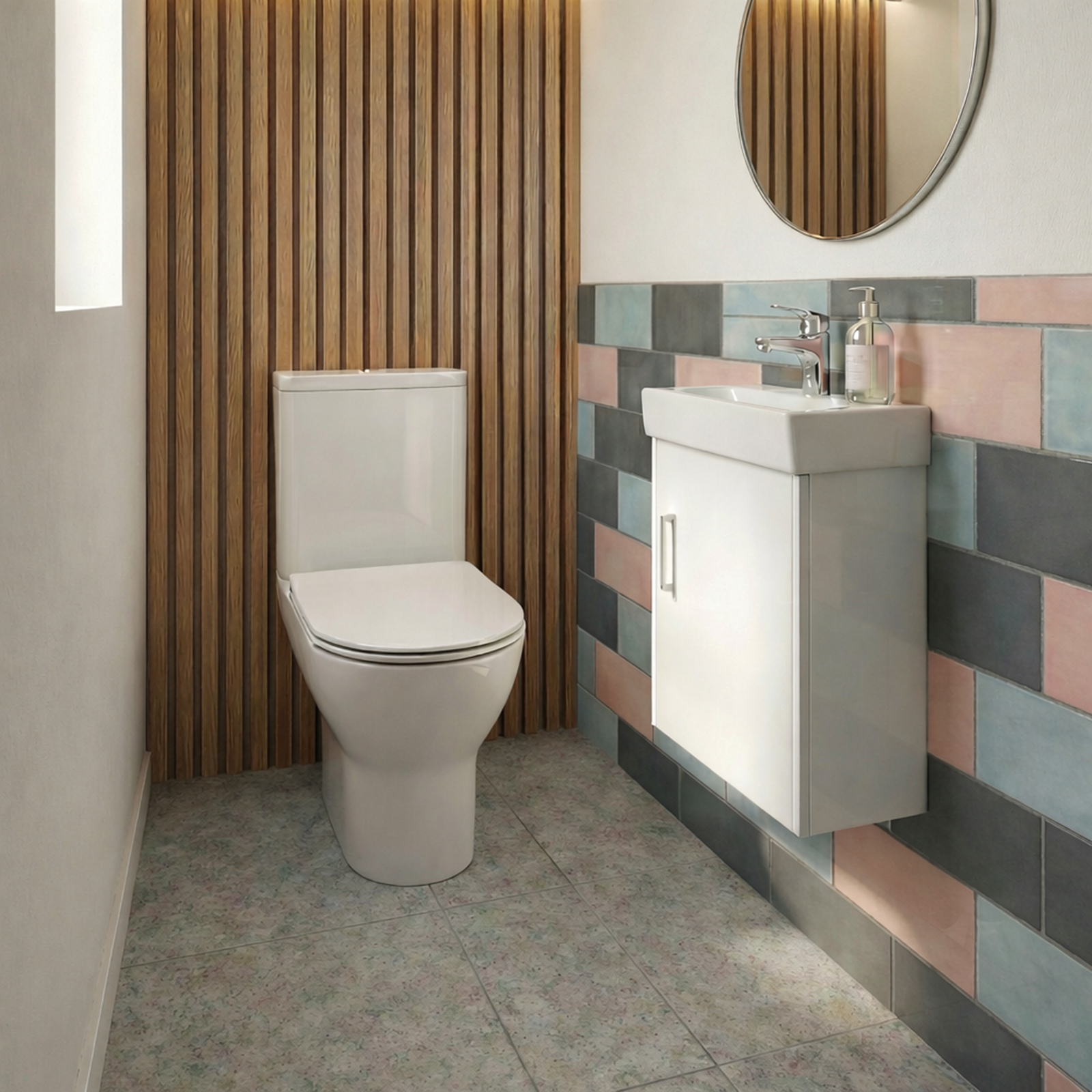 Modern bathroom with a toilet, sink, and colorful tiled wall.