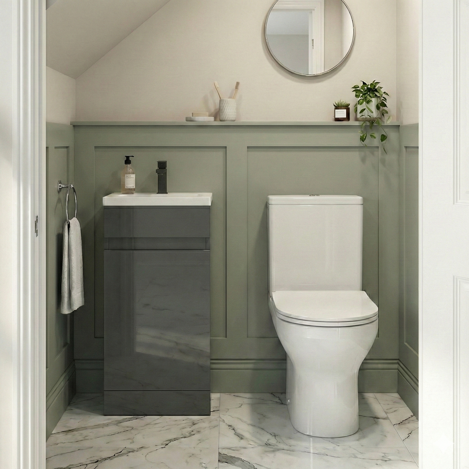 Bathroom with green vanity unit, white toilet, and round mirror.