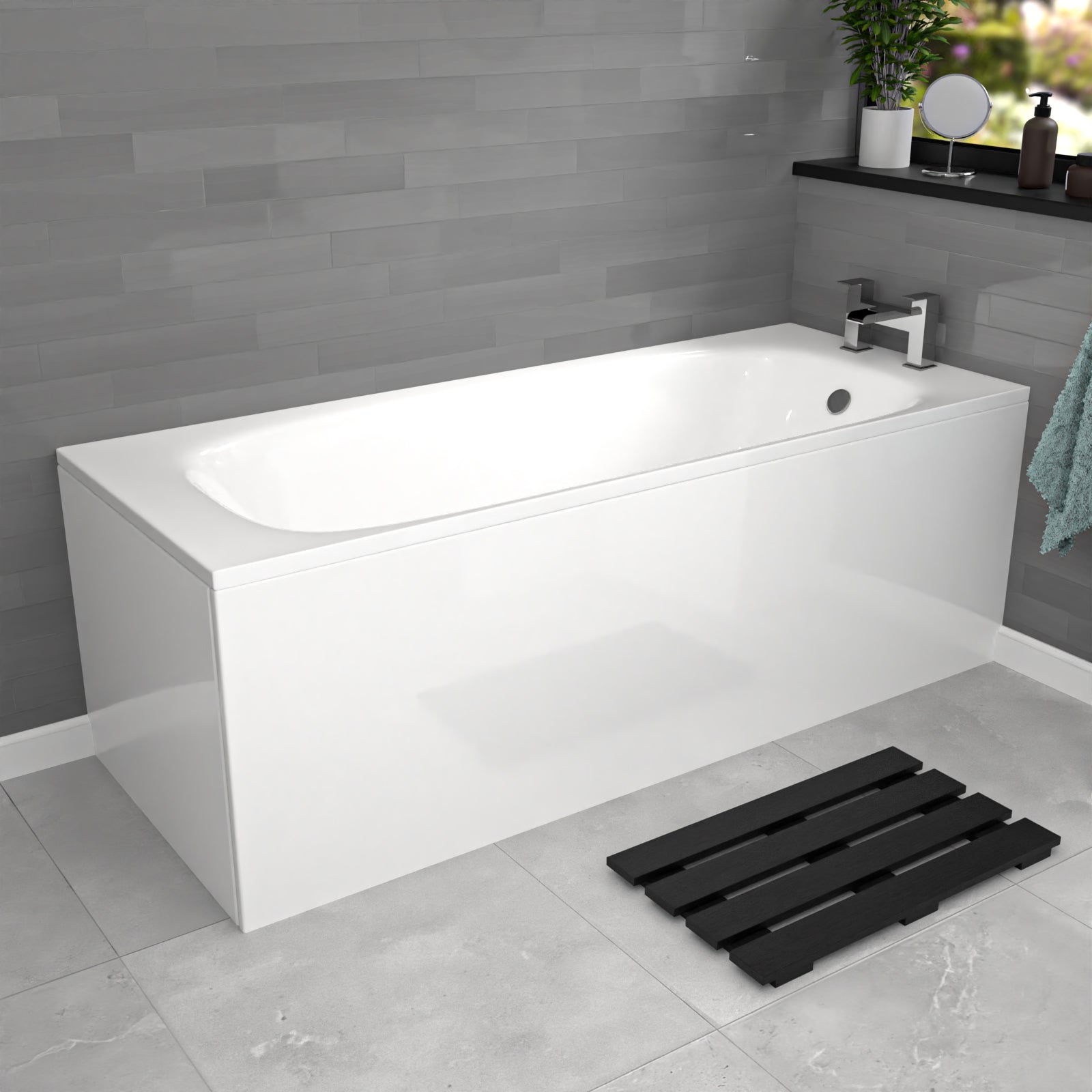 White bathtub in a modern bathroom with gray tiles and a black bath mat.