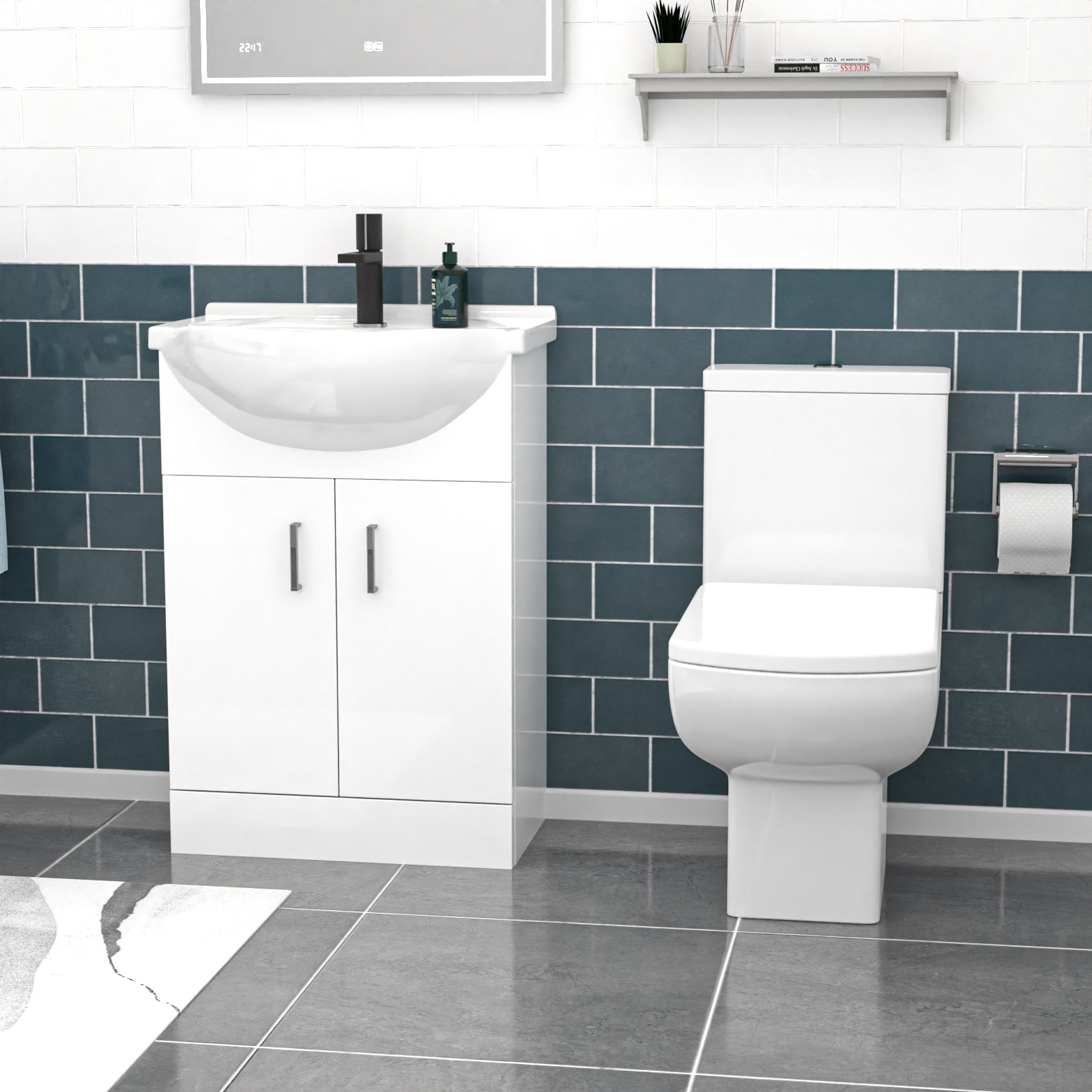 Bathroom setup with white vanity unit and toilet against a blue tiled wall.