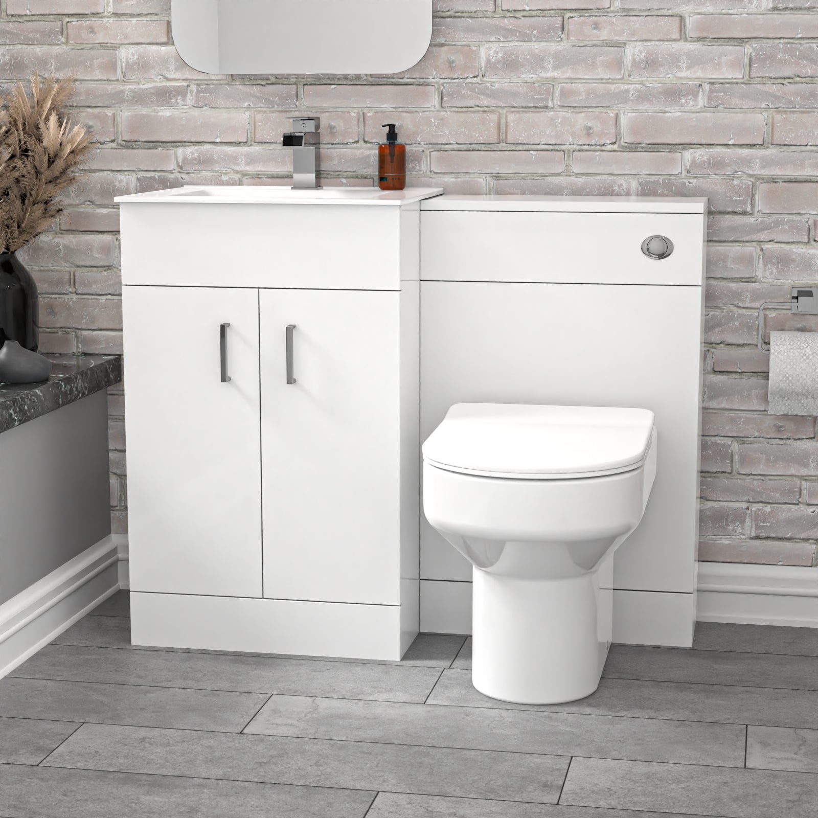 Bathroom setup with white vanity unit and toilet against a stone-textured wall.