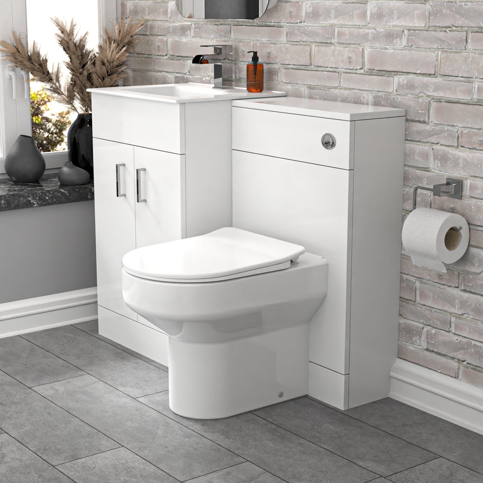 Bathroom setup with a toilet and vanity unit against a stone wall.
