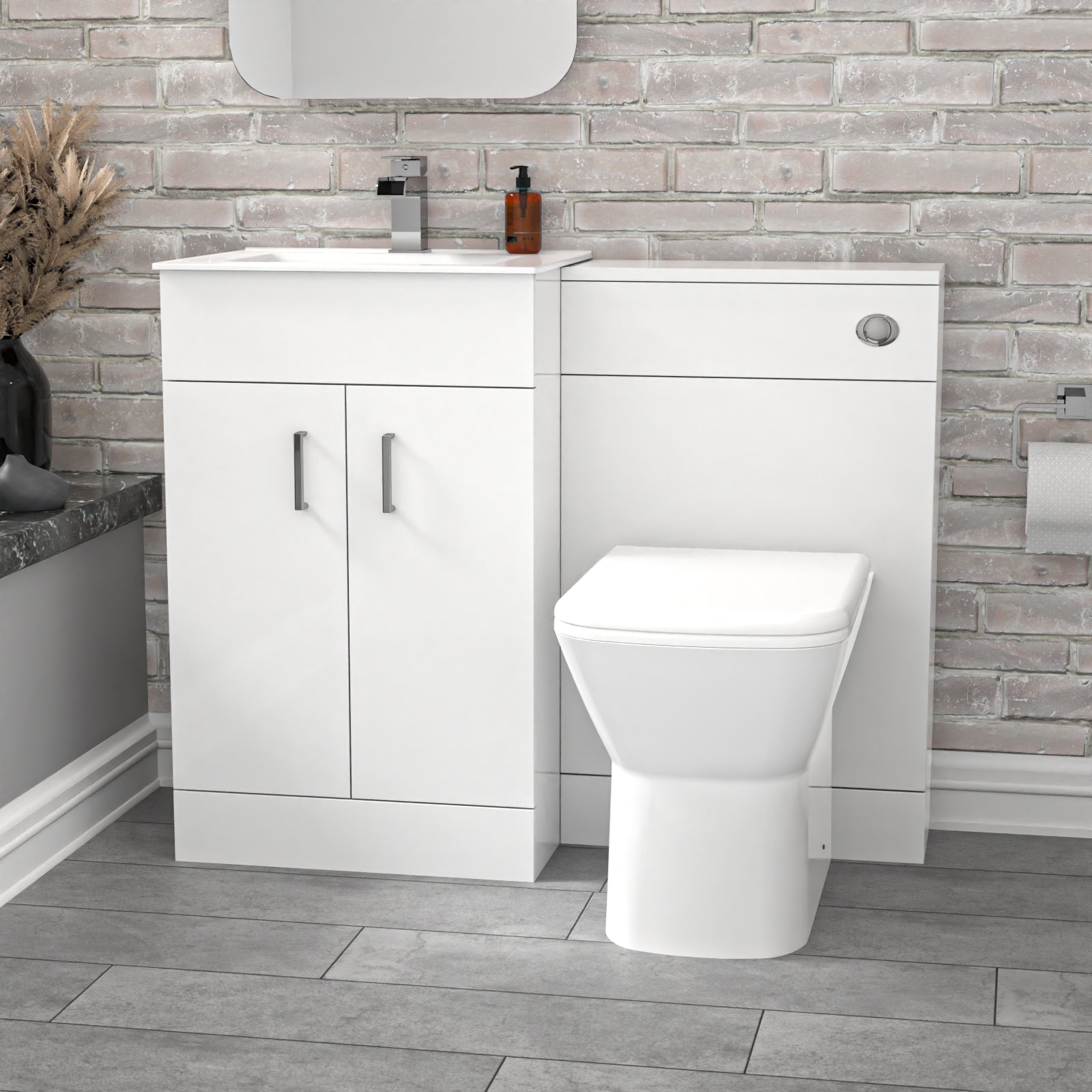 Bathroom setup with white vanity unit and toilet against a brick-patterned wall.
