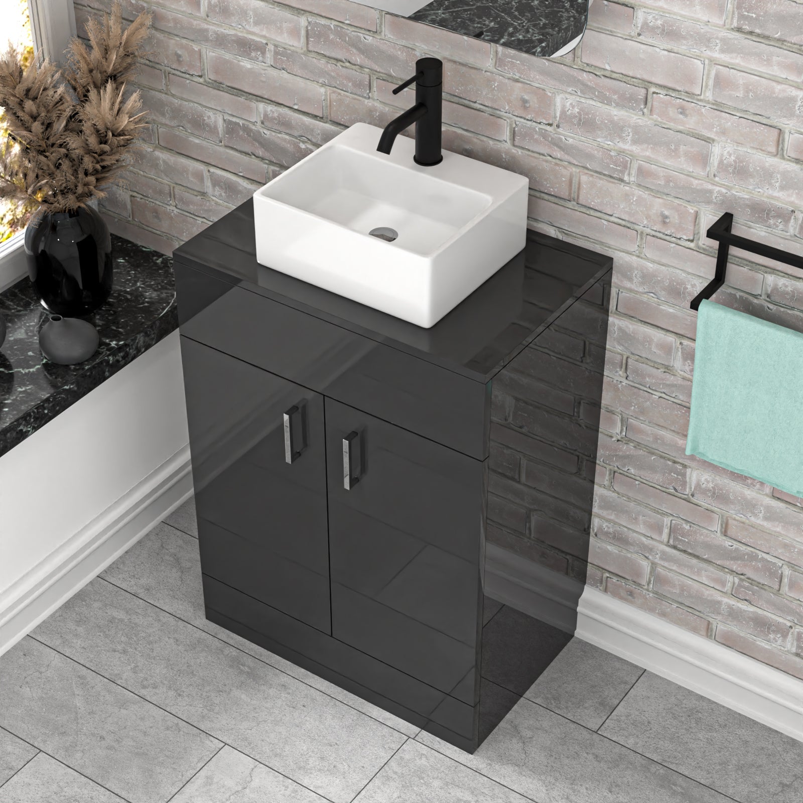 Bathroom vanity with black cabinet and white sink against a brick wall.