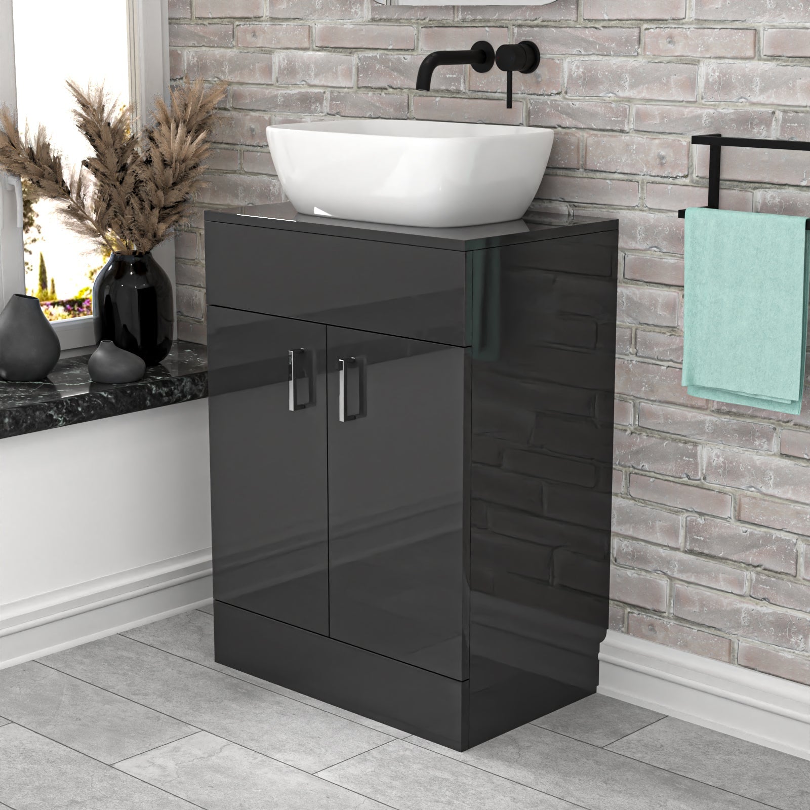 Bathroom vanity with black cabinet and white basin against a brick wall.