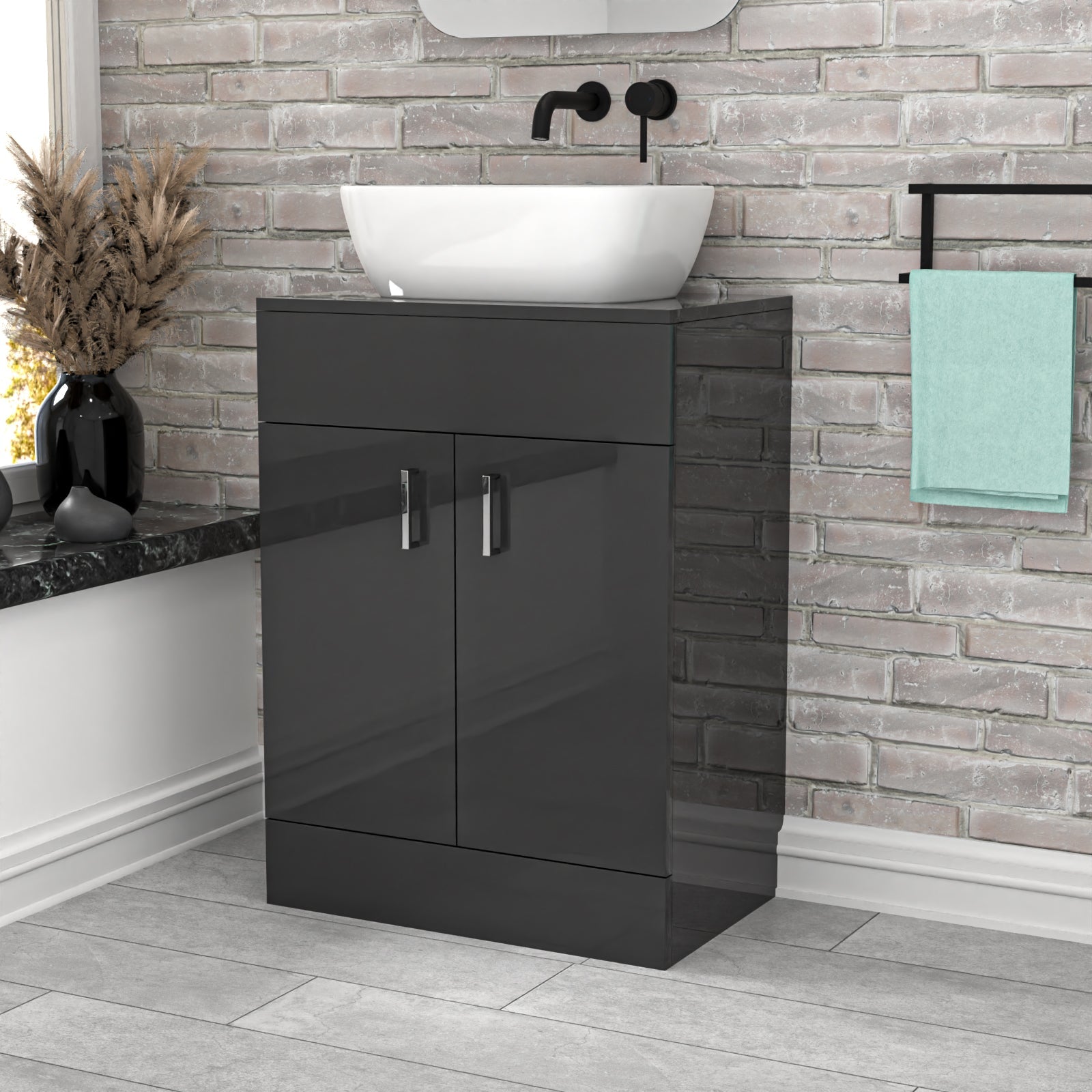 Bathroom vanity with black cabinet and white basin against a stone wall.