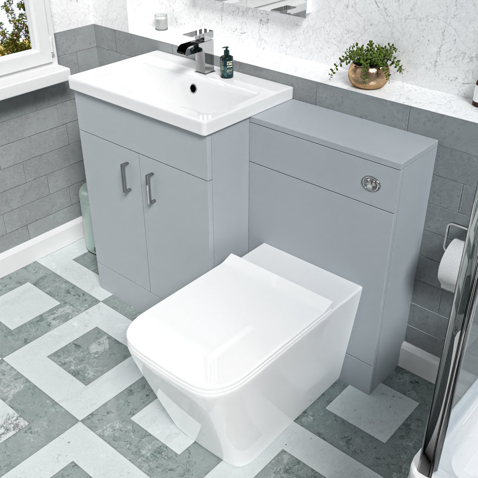 Bathroom setup with gray vanity unit, white sink, and toilet.