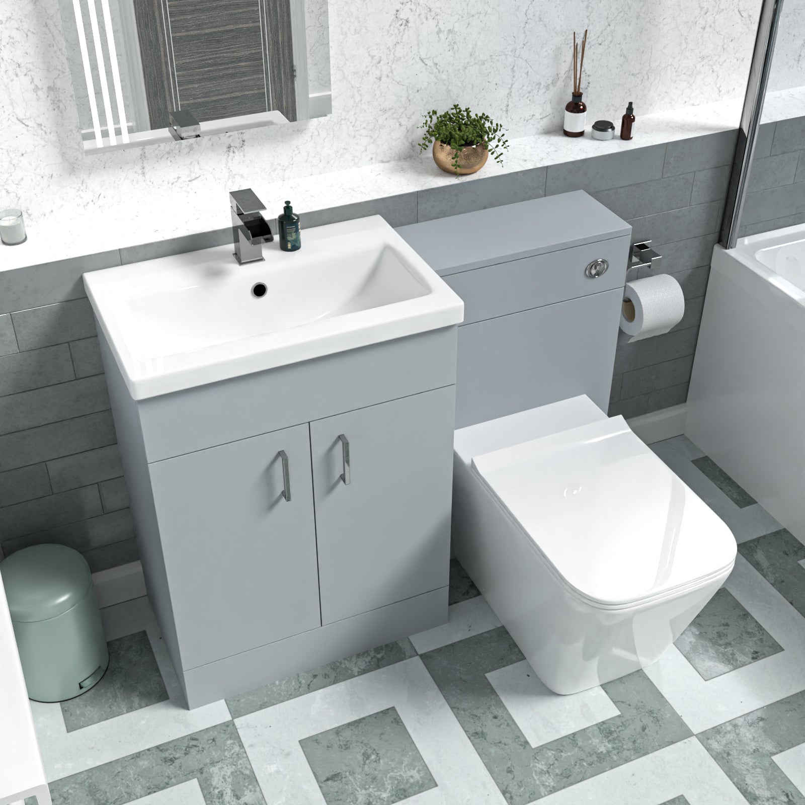 Bathroom setup with gray vanity unit, white sink, and toilet.