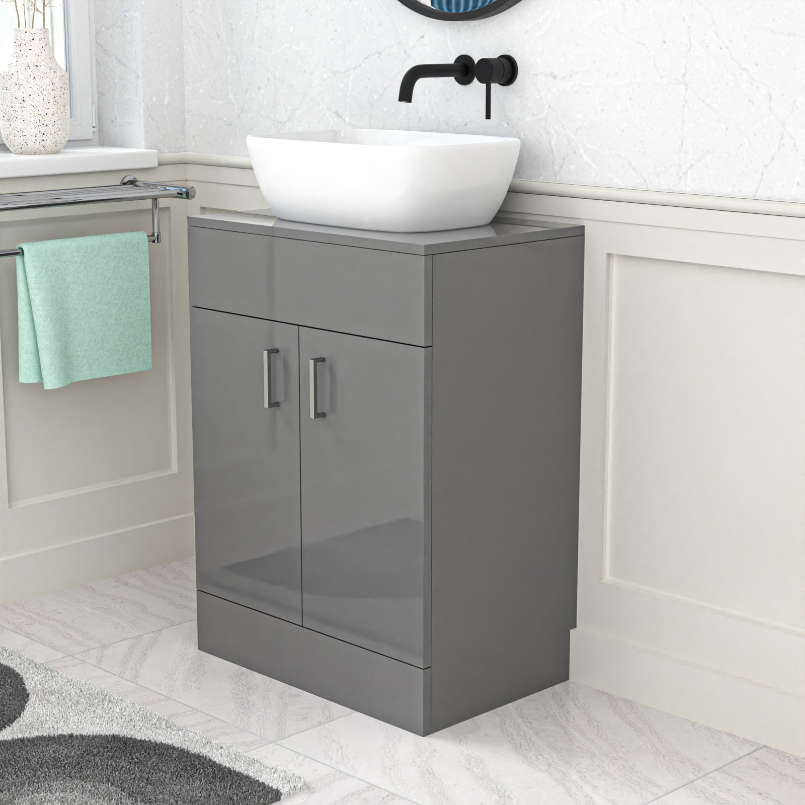 Gray vanity unit with white basin and black faucet in a bathroom setting.